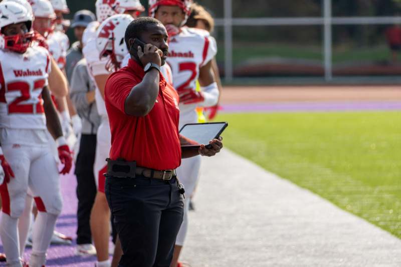 a football coach holding a tablet