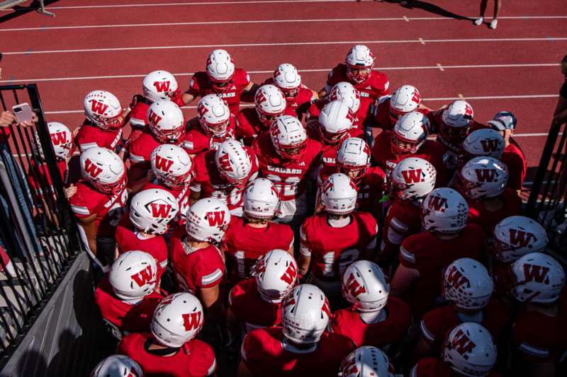 Football vs Ohio Wesleyan (10/11/25) - a group of football players in red uniforms