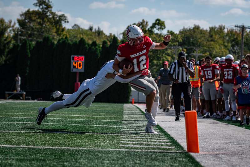a football player in a red uniform with a football in the air