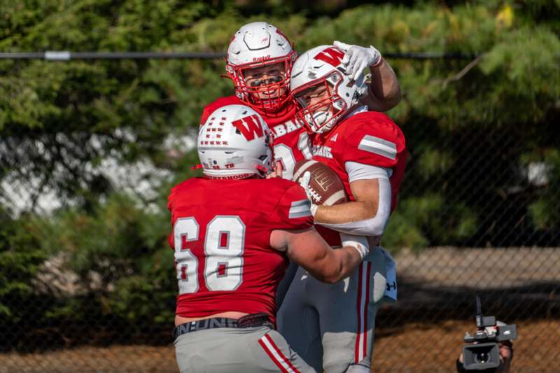 a group of football players hugging