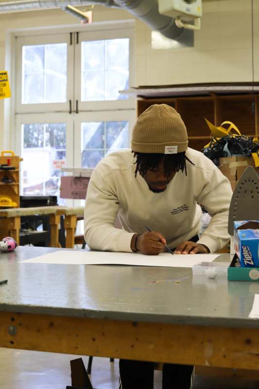 a man writing on a piece of paper