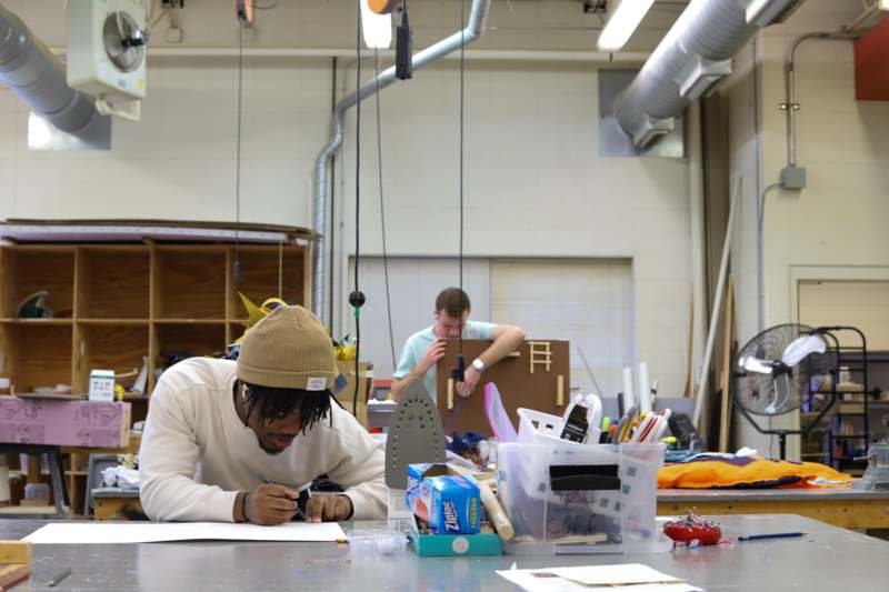 a man writing on a piece of paper