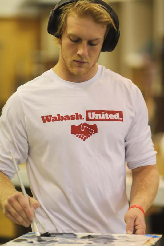 a man wearing headphones and a white shirt