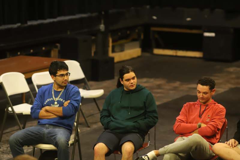 a group of men sitting in chairs