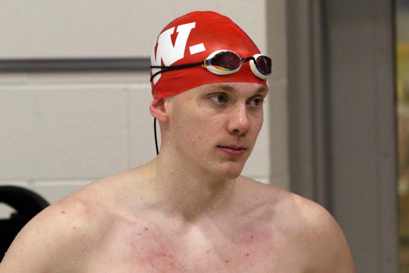 a man wearing a swim cap and goggles
