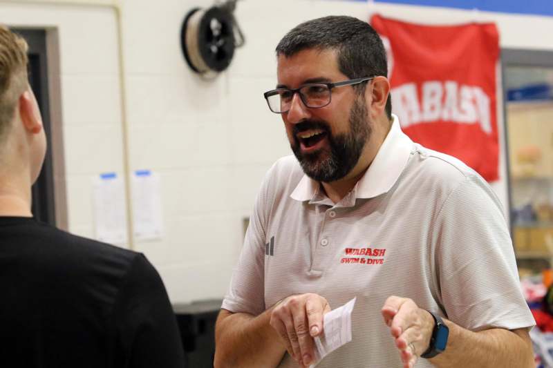 a man in glasses laughing
