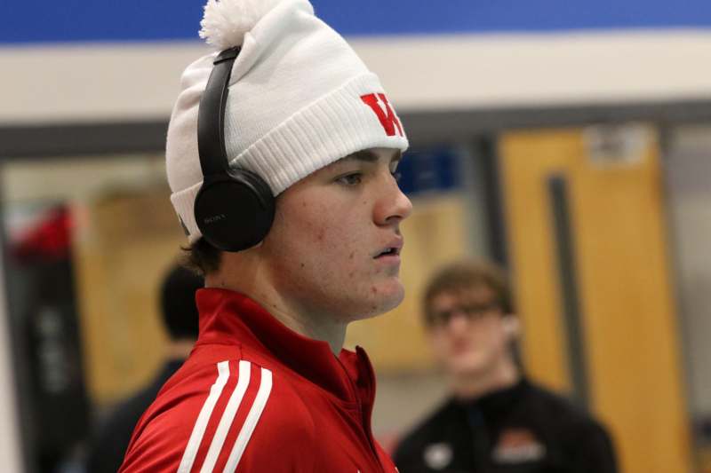 a man wearing a white beanie and headphones