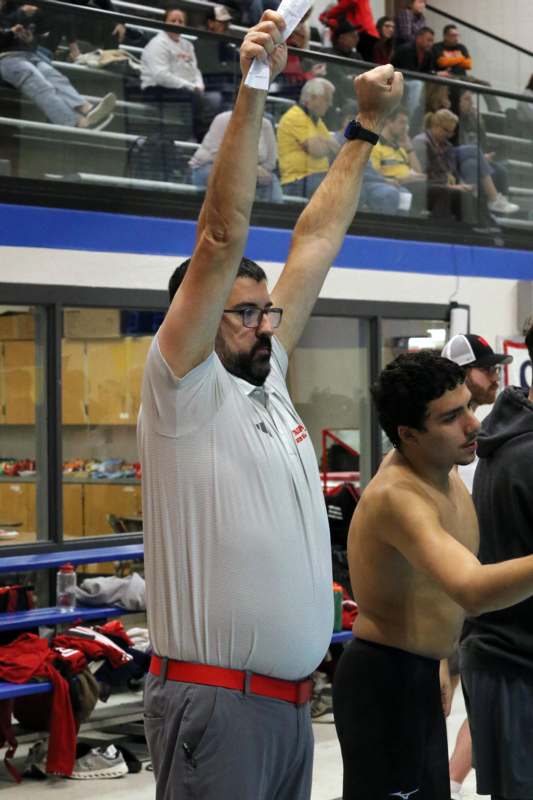 a man with his arms up in the air