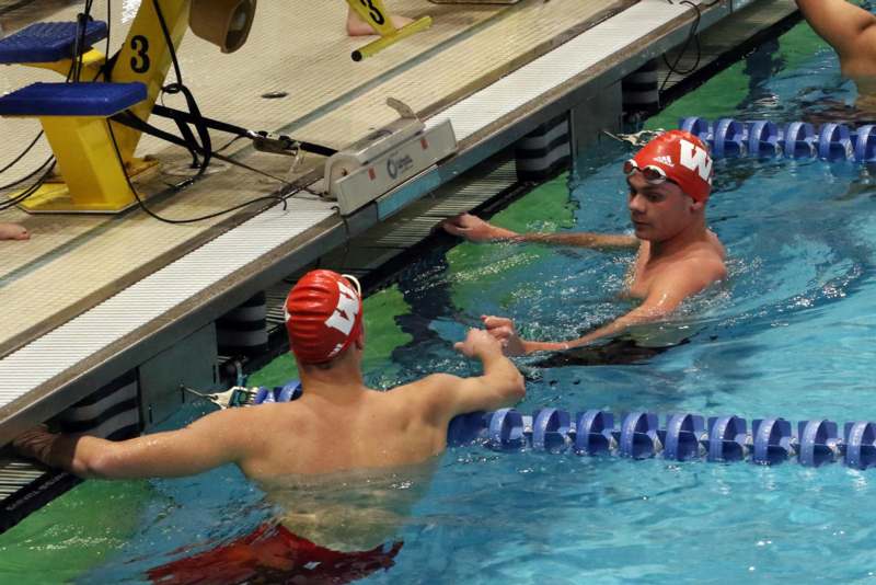 a group of men in a swimming pool