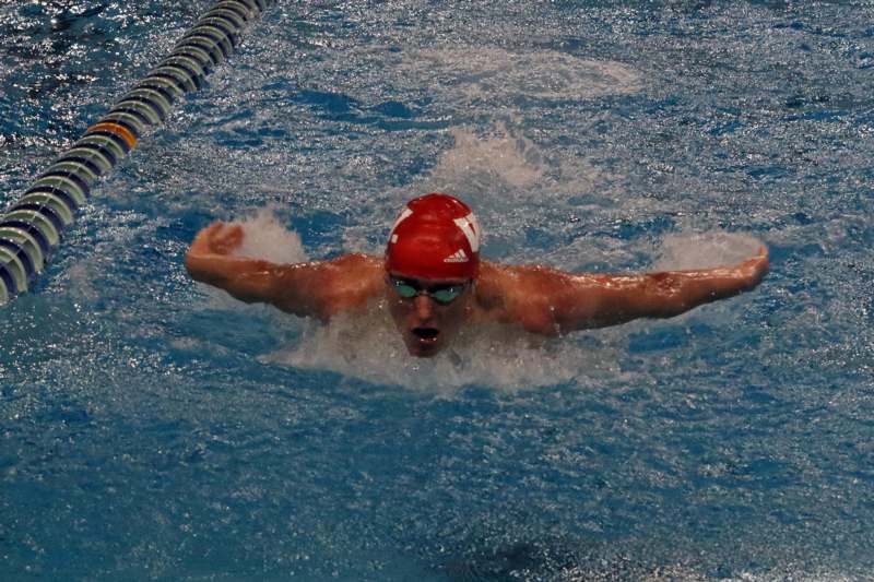 a man swimming in a pool