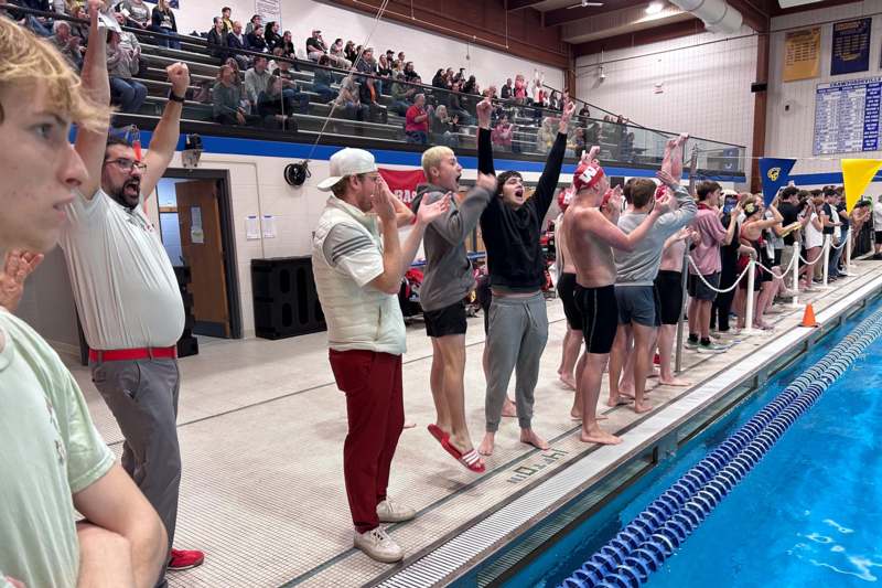 a group of people standing on a swimming pool