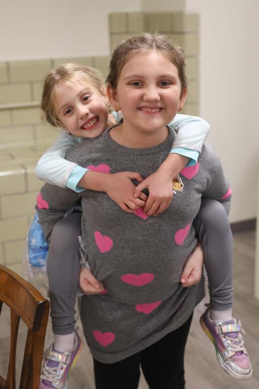 a girl on a woman's back