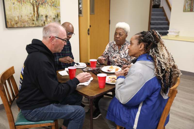 a group of people sitting around a table eating food