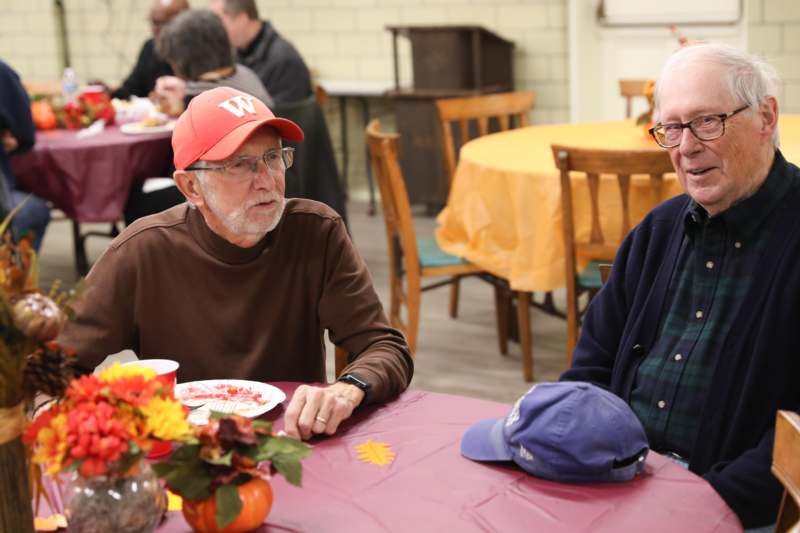 a group of men sitting at a table