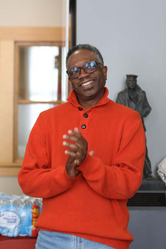 a man in an orange sweater