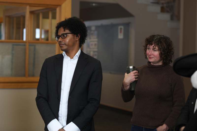 a man and woman standing in a hallway