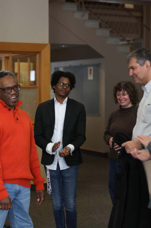 a group of people standing in a hallway