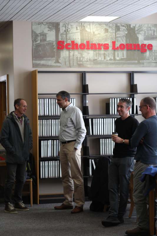 a group of men standing in a library