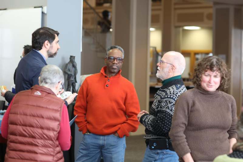 a group of people standing around each other