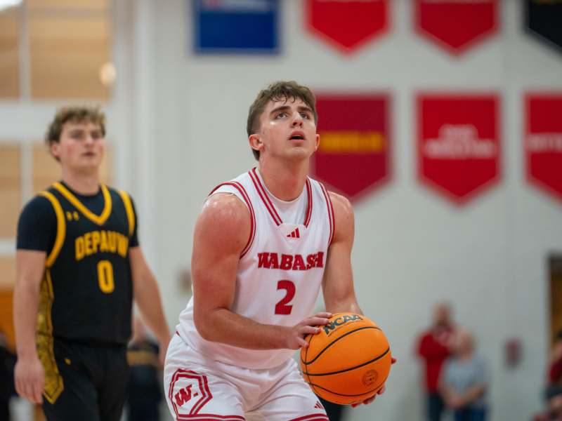 a man in a basketball uniform holding a basketball