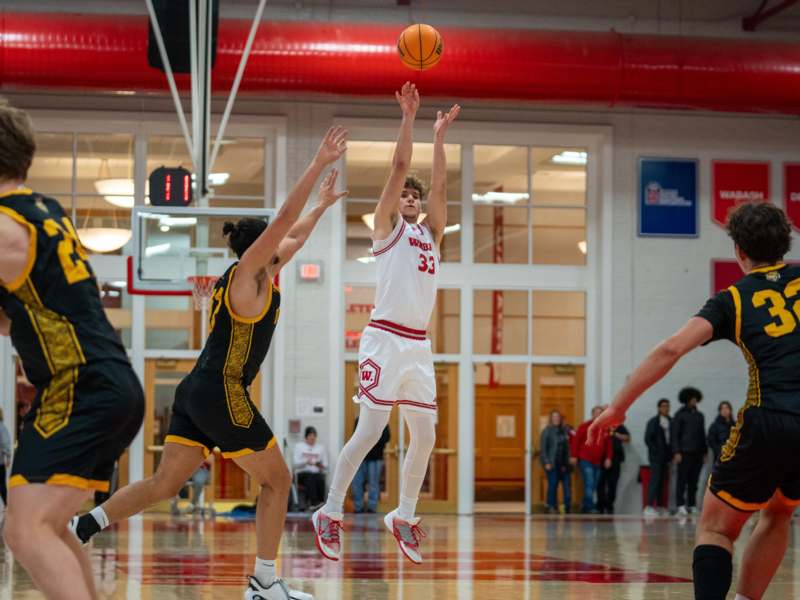 a basketball player jumping to shoot a basketball