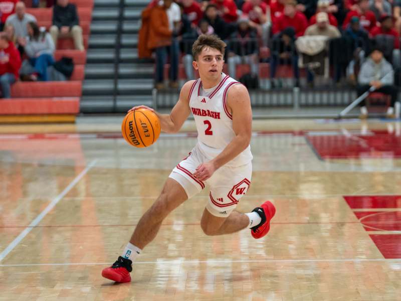 a man in a basketball uniform dribbling a basketball