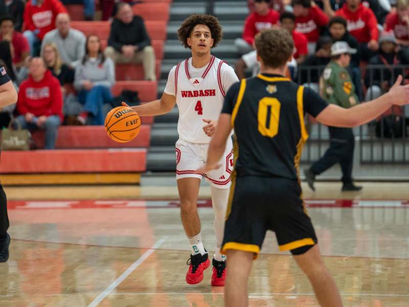 a basketball player in a uniform dribbling a basketball