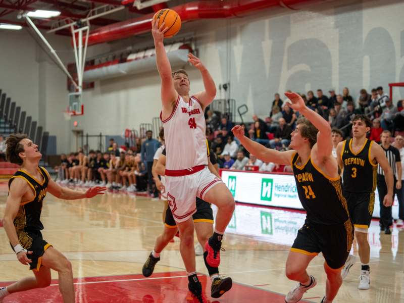 a group of men playing basketball
