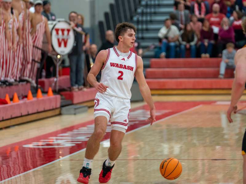 a man in a basketball uniform dribbling a basketball
