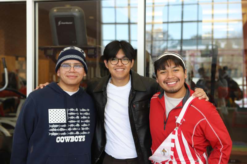 a group of men standing together smiling