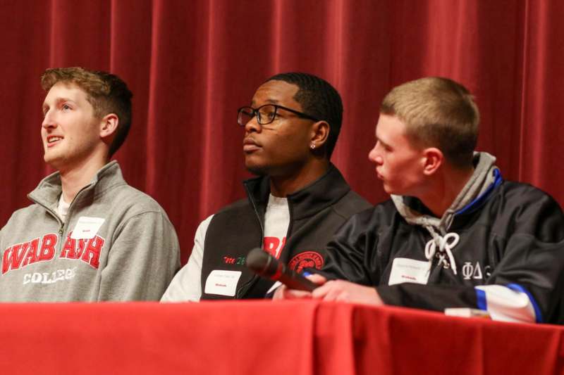 a group of men sitting at a table