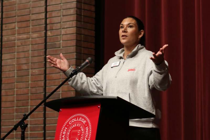 a woman standing at a podium with a microphone