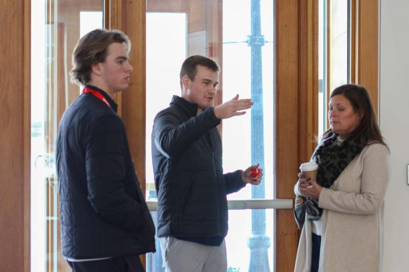a group of people standing in front of a window