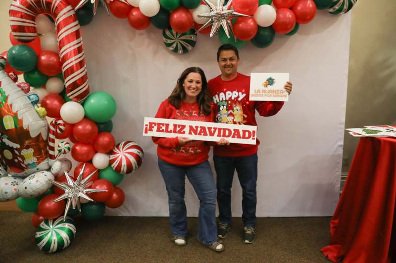 a man and woman holding signs
