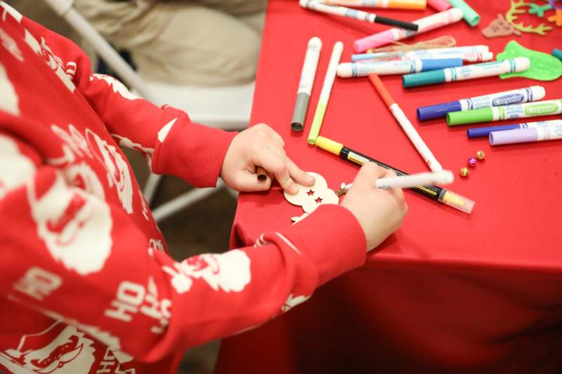 a child painting a christmas ornament