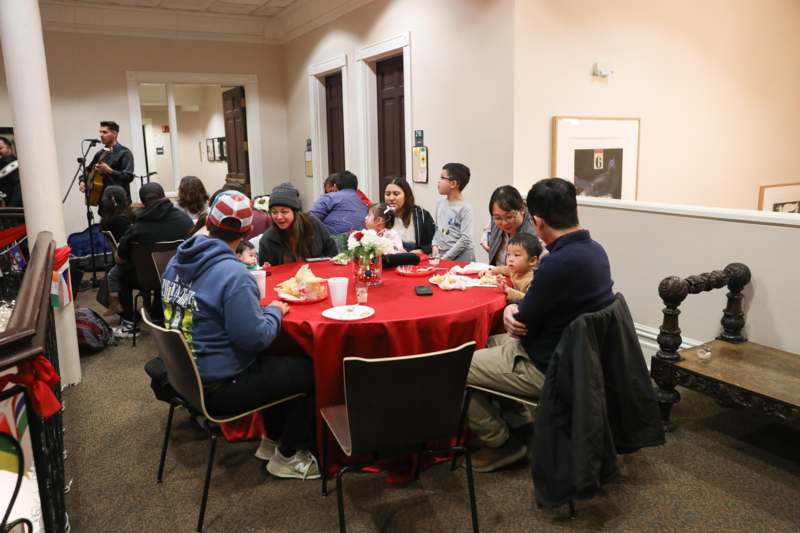 a group of people sitting around a round table