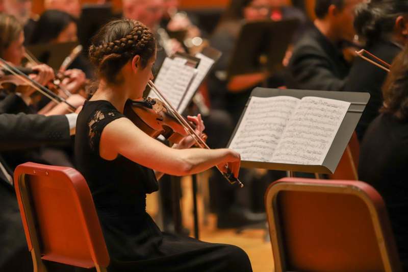 a woman playing a violin