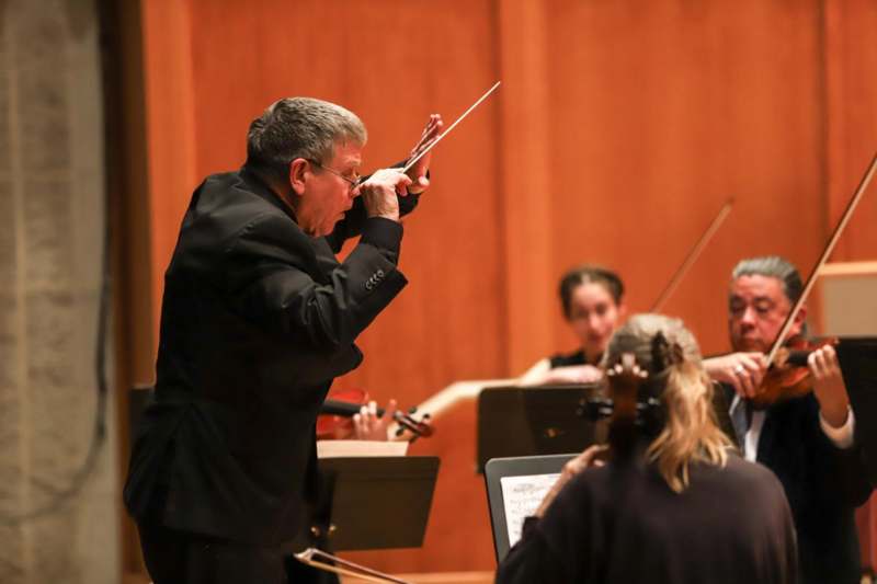 a man playing a violin