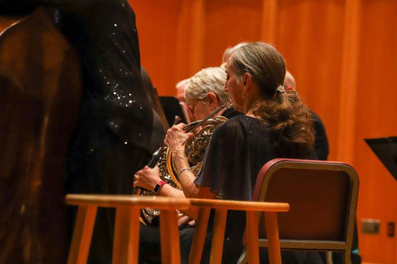 a group of people playing a horn
