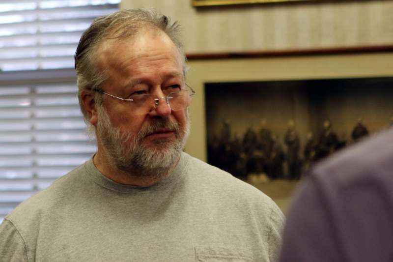 a man with glasses looking at something