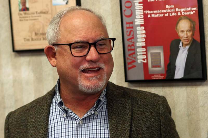 a man in glasses smiling