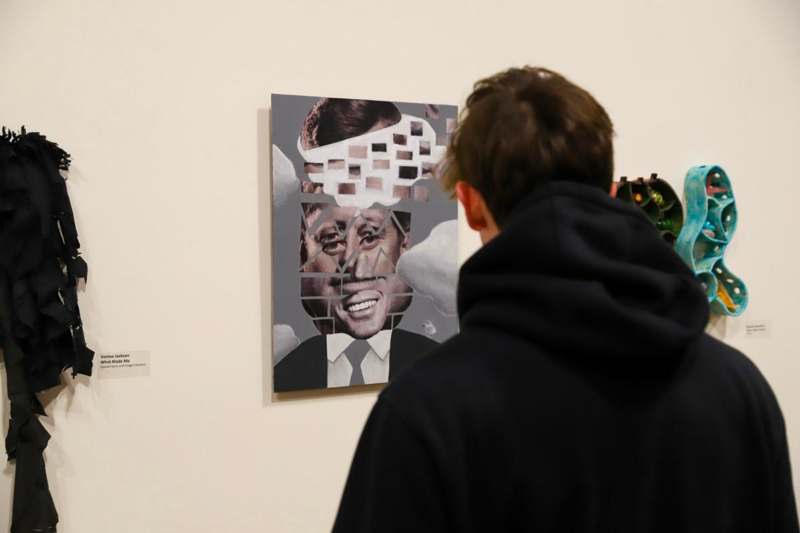 a person looking at a painting on a wall