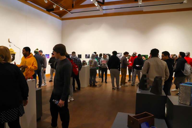 Zeitgeist Student Art Show - a group of people in a room with art