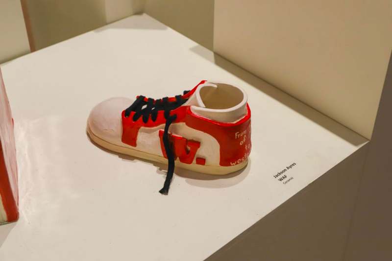 a red and white shoe on a white surface