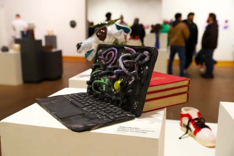 a laptop with a book on top of it