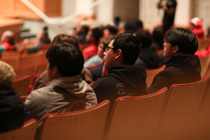 a group of people sitting in a lecture hall