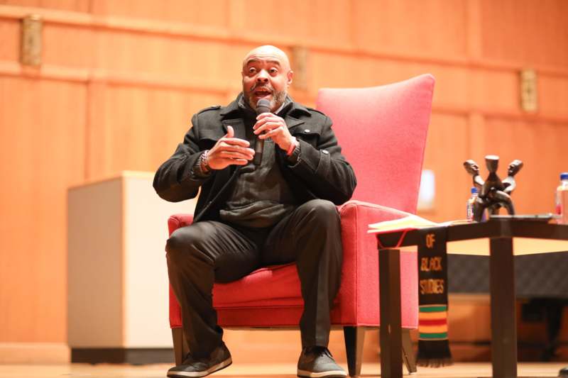 a man sitting in a chair with a microphone