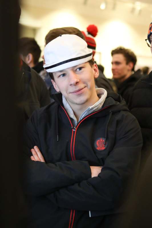 a man with arms crossed in a crowd