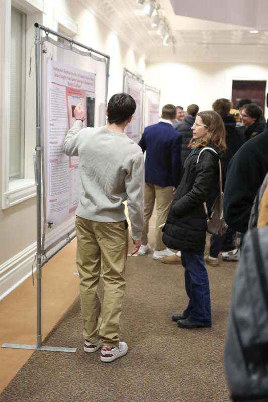 a man pointing at a poster