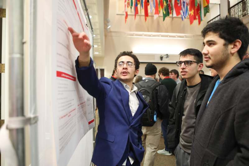 a man pointing at a poster